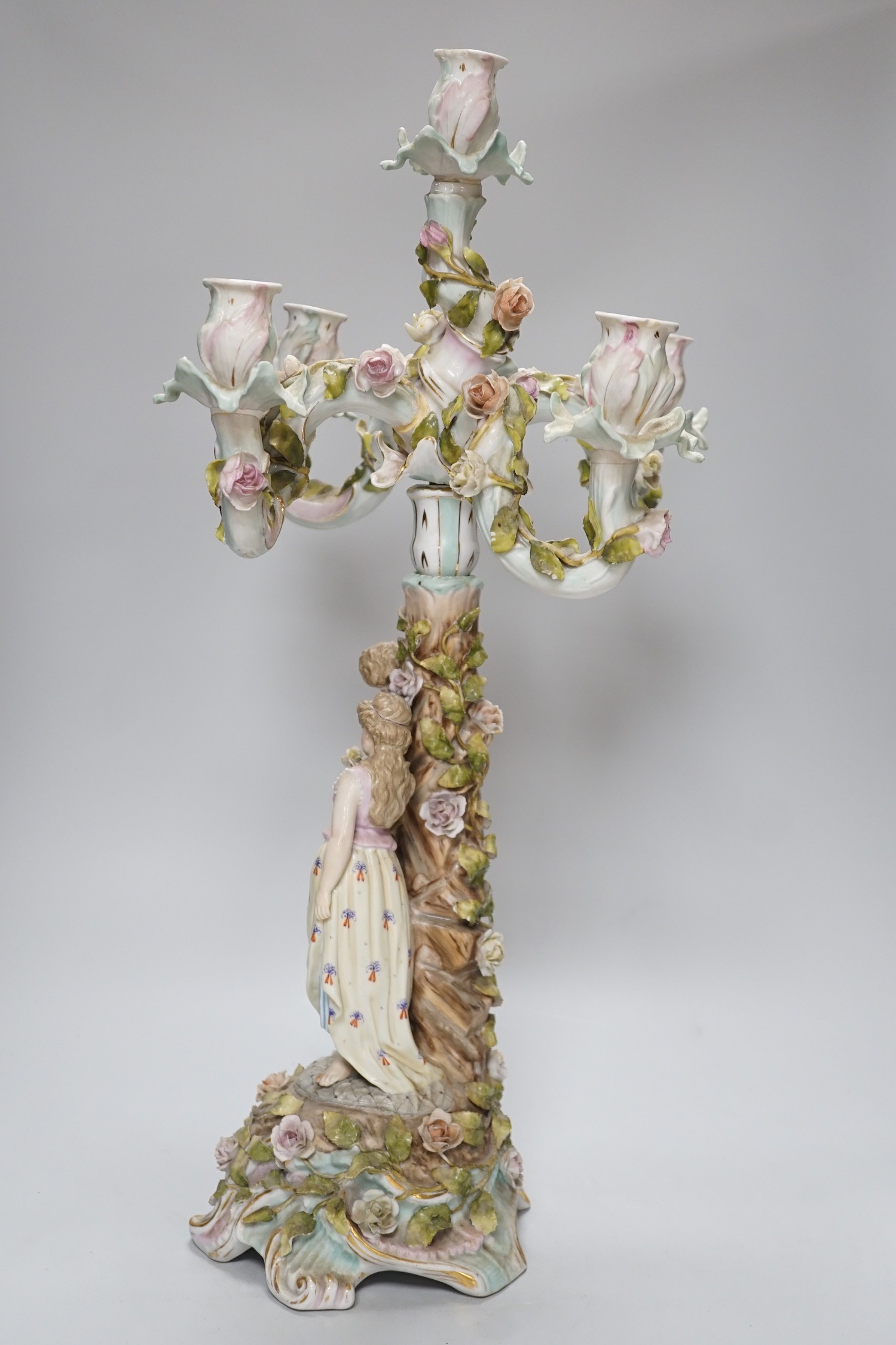 A Sitzendorf-style floral encrusted 4 branch candelabra, 57cms high